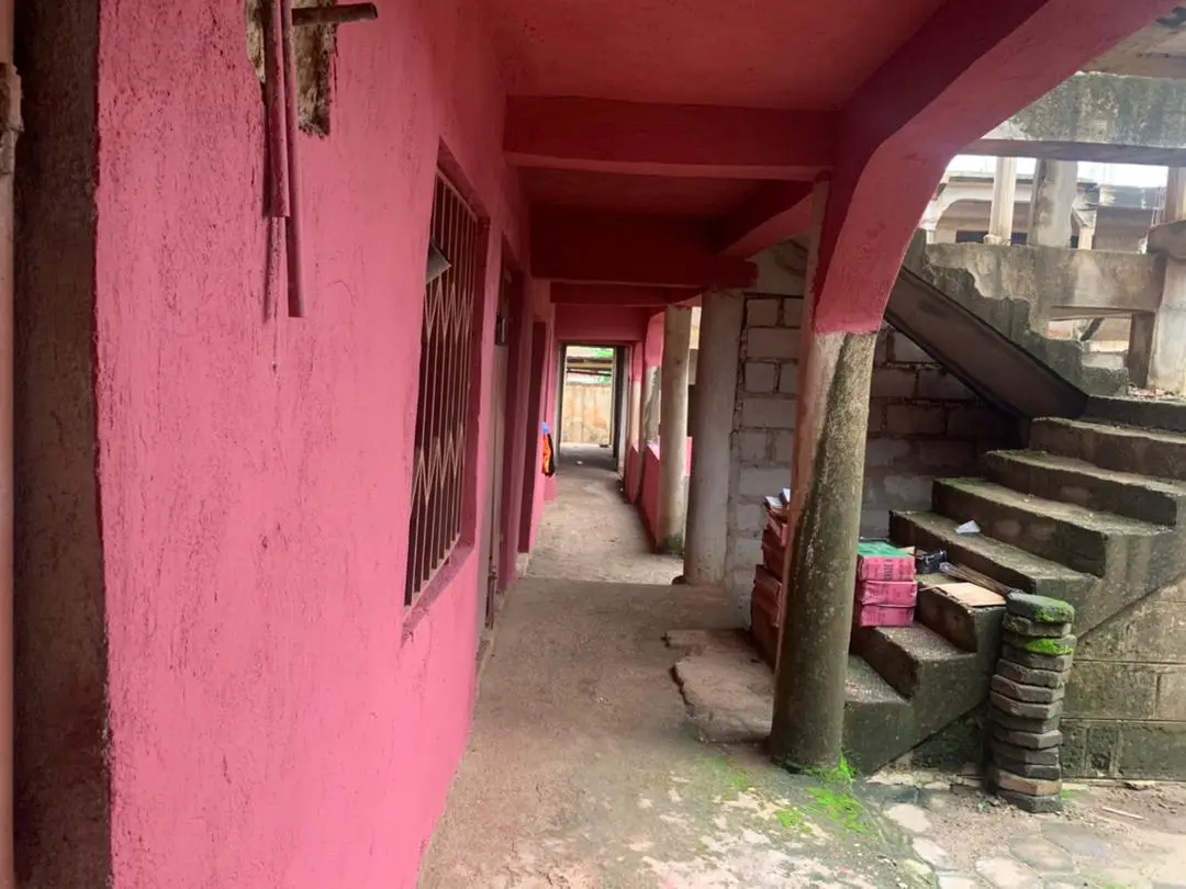 The covered walkway along the classrooms in Daban, with the concrete stairs to the upper floor